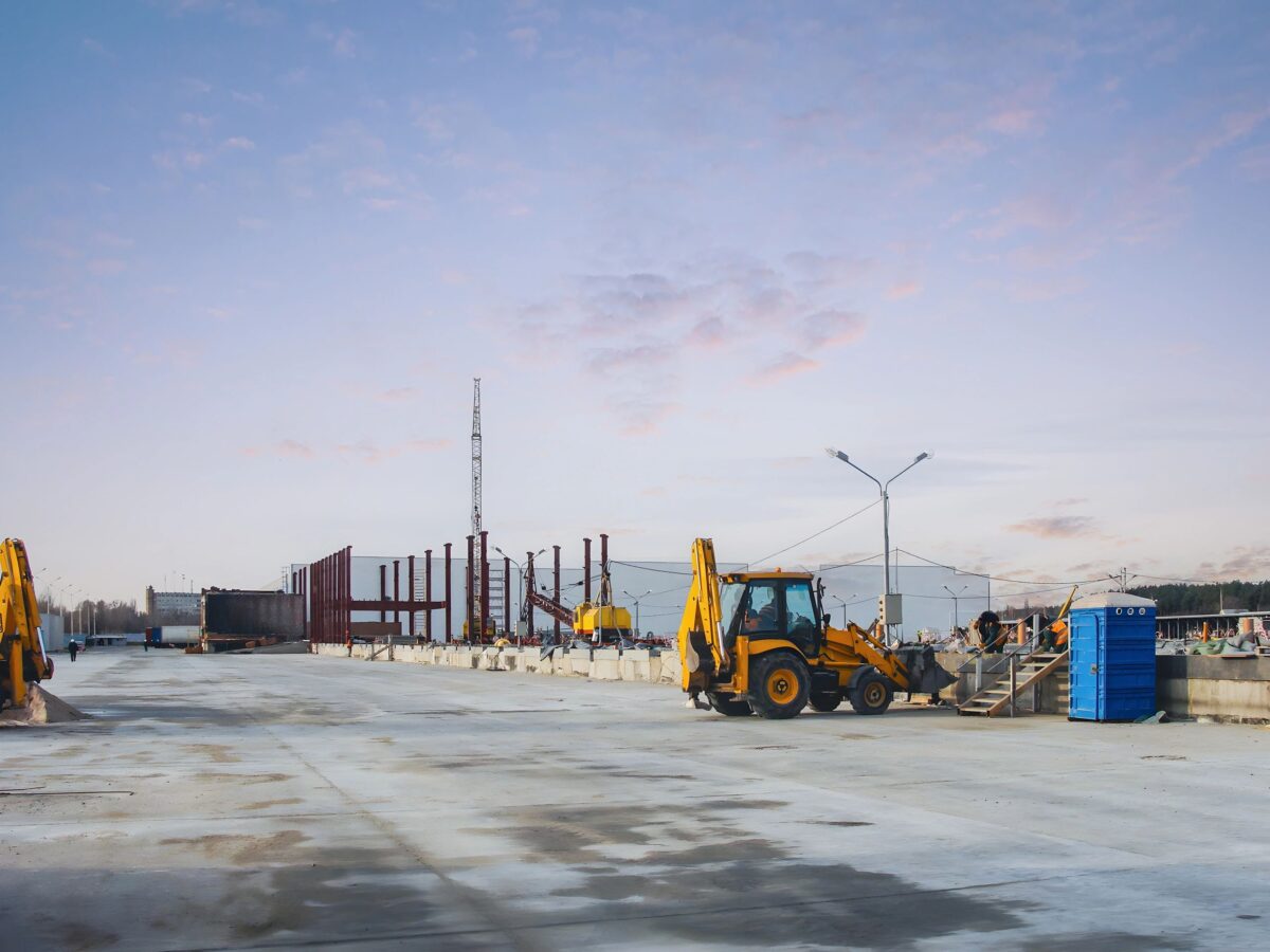 Heavy equipment on an active jobsite under a cloudy sky